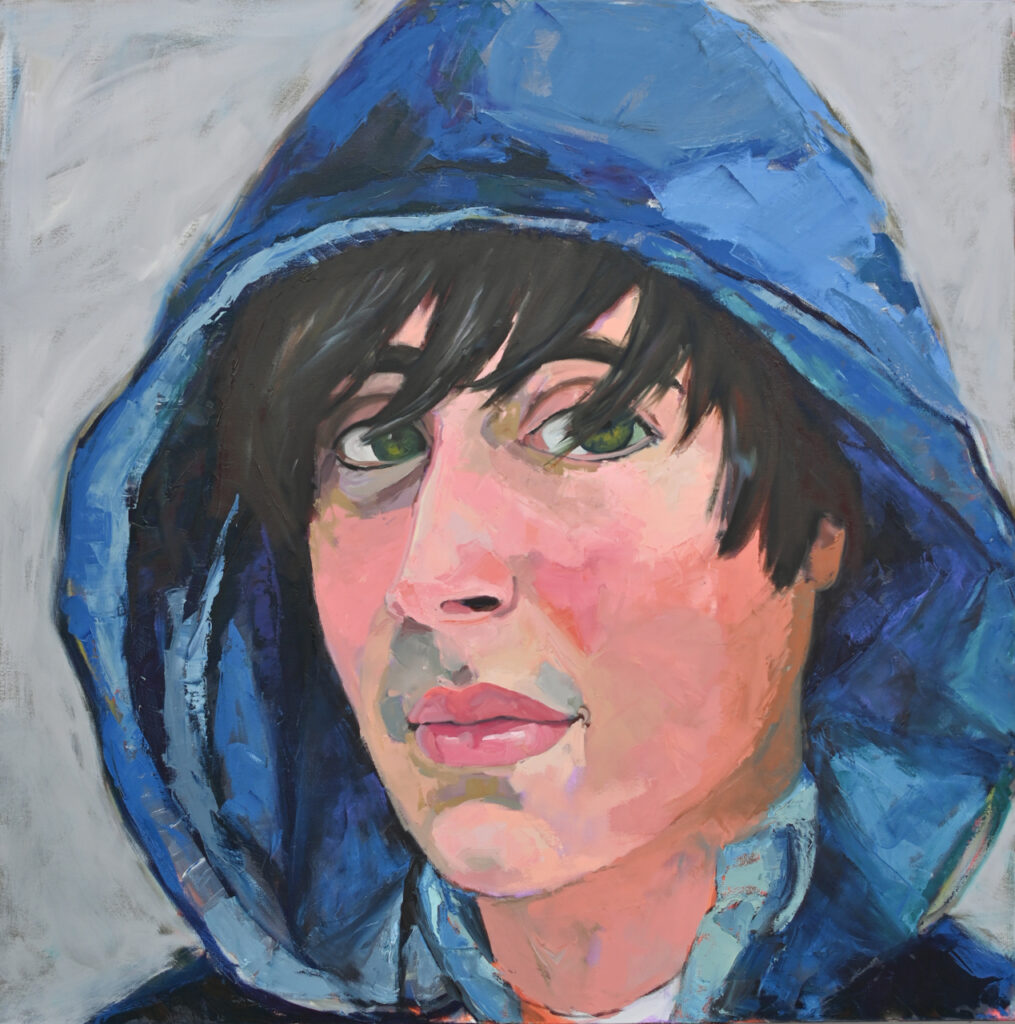 Young man with black hair in a blue hoodie