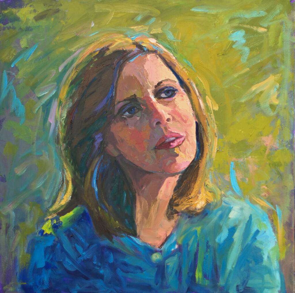 Woman with brown hair wearing a blue shirt