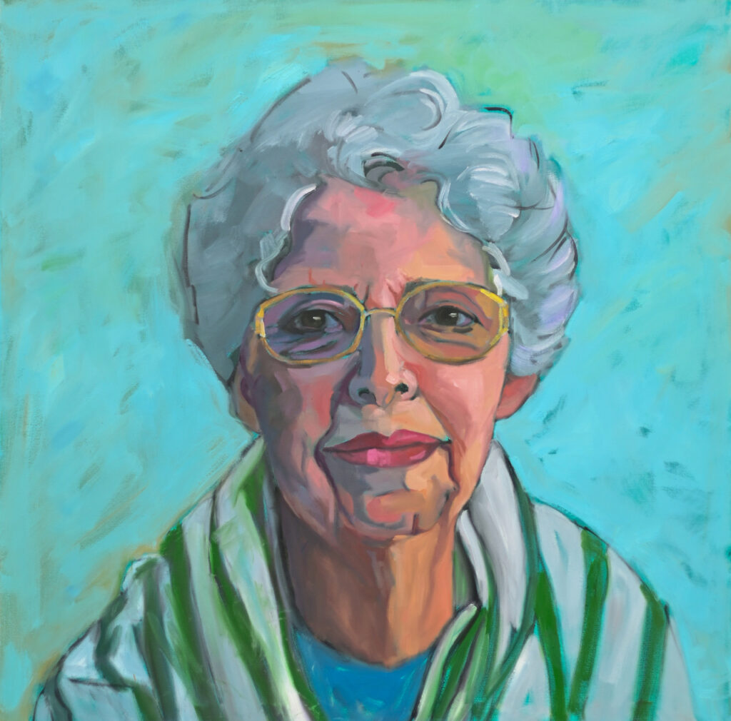 Old woman with grey hair and a green and white striped shawl