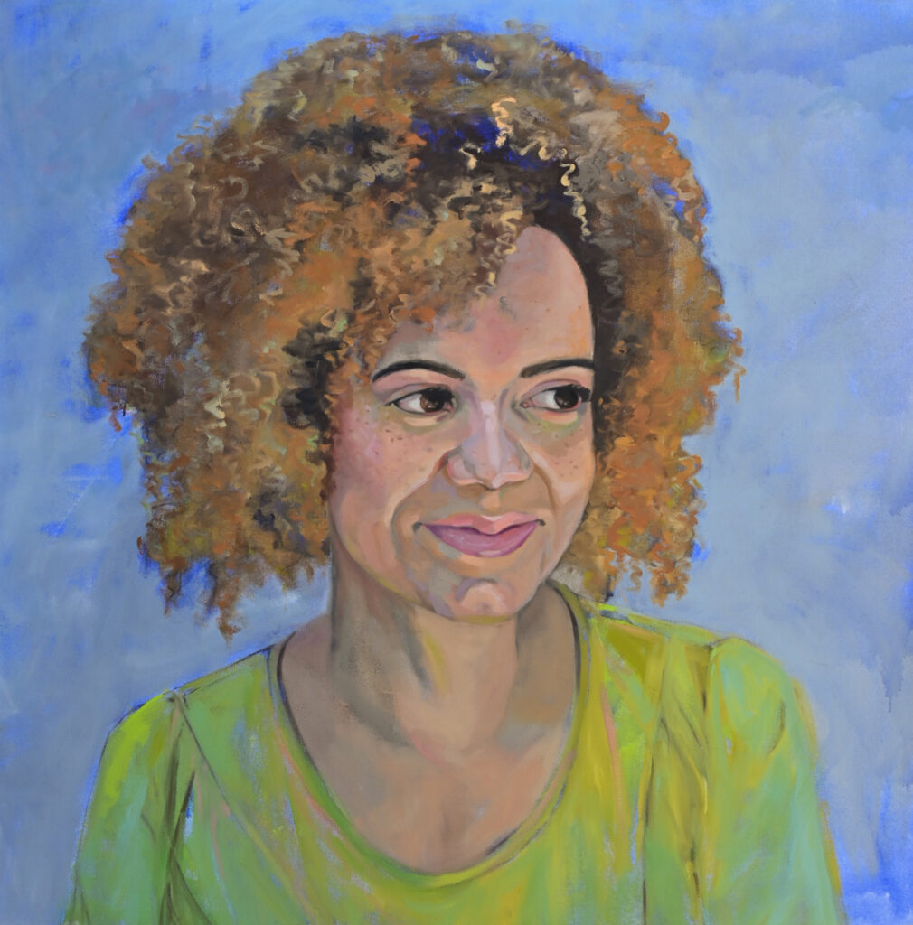 Woman in a green shirt with a blonde afro