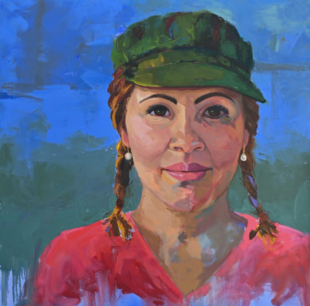 Latina with braids in a green hat